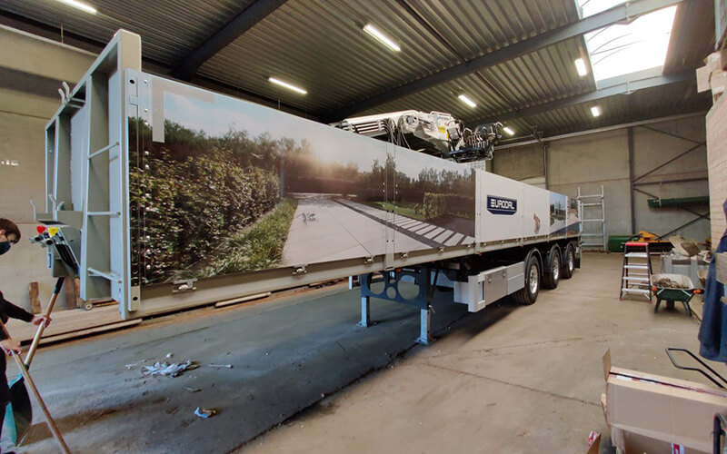 Open trailer met belettering